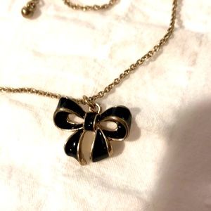 Gold tone and black enamel bow necklace